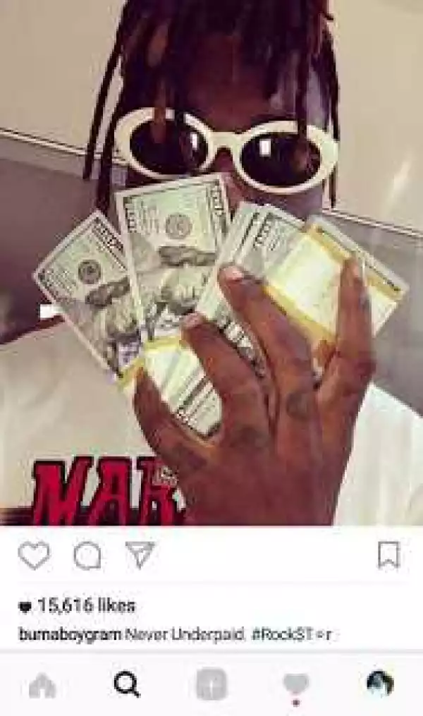 Burna Boy Brags About Earning N15 million Per Show With Stacks Of Dollars [Photos]